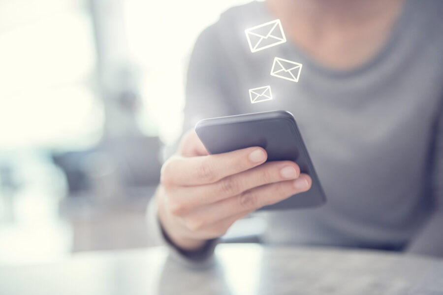 Closeup Woman hand using mobile smartphone with email icon, Emai